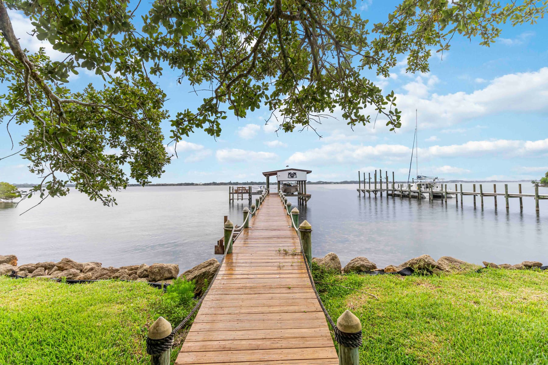 Private dock with boat lift and boathouse on the Indian River